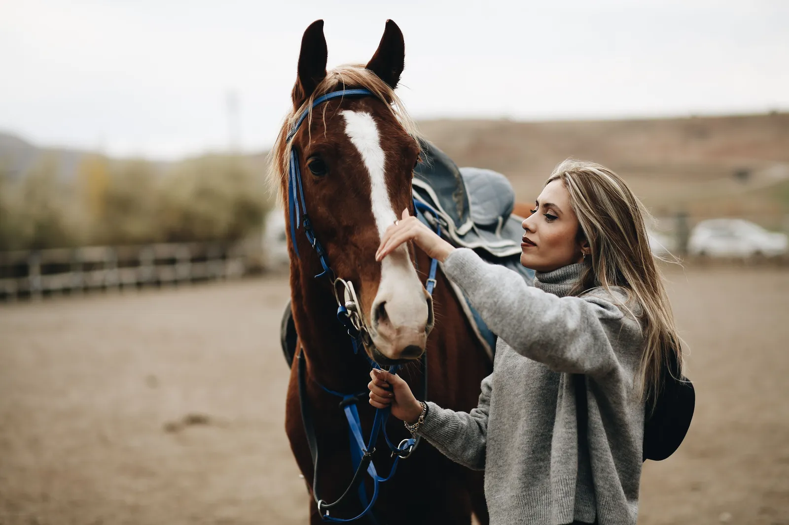 Woman petting her horse — Sakti Atelier memorial jewelry